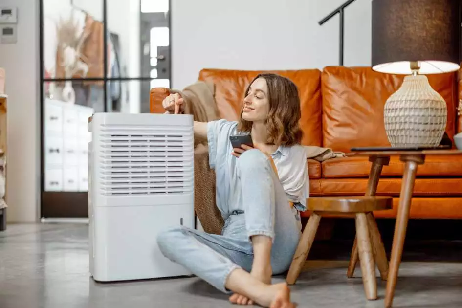 a lady with a relief of cooking-odor-free living space when using an air purifier