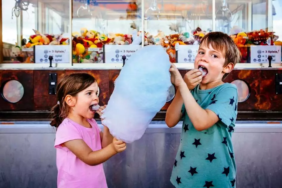 boy and girl happy eating cotton candy