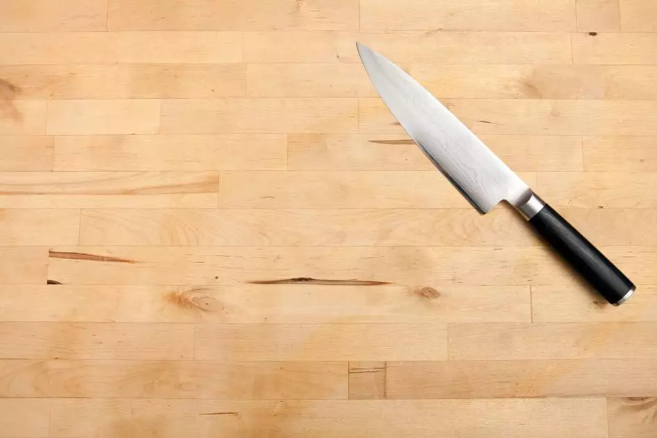 budget friendly chef knife under $100 on wood cutting board