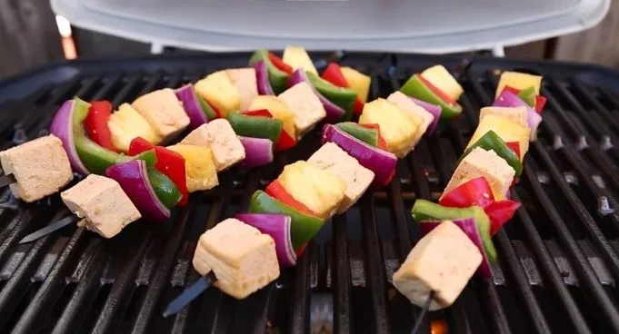 healthy vegetables are grilled on a gas grill 